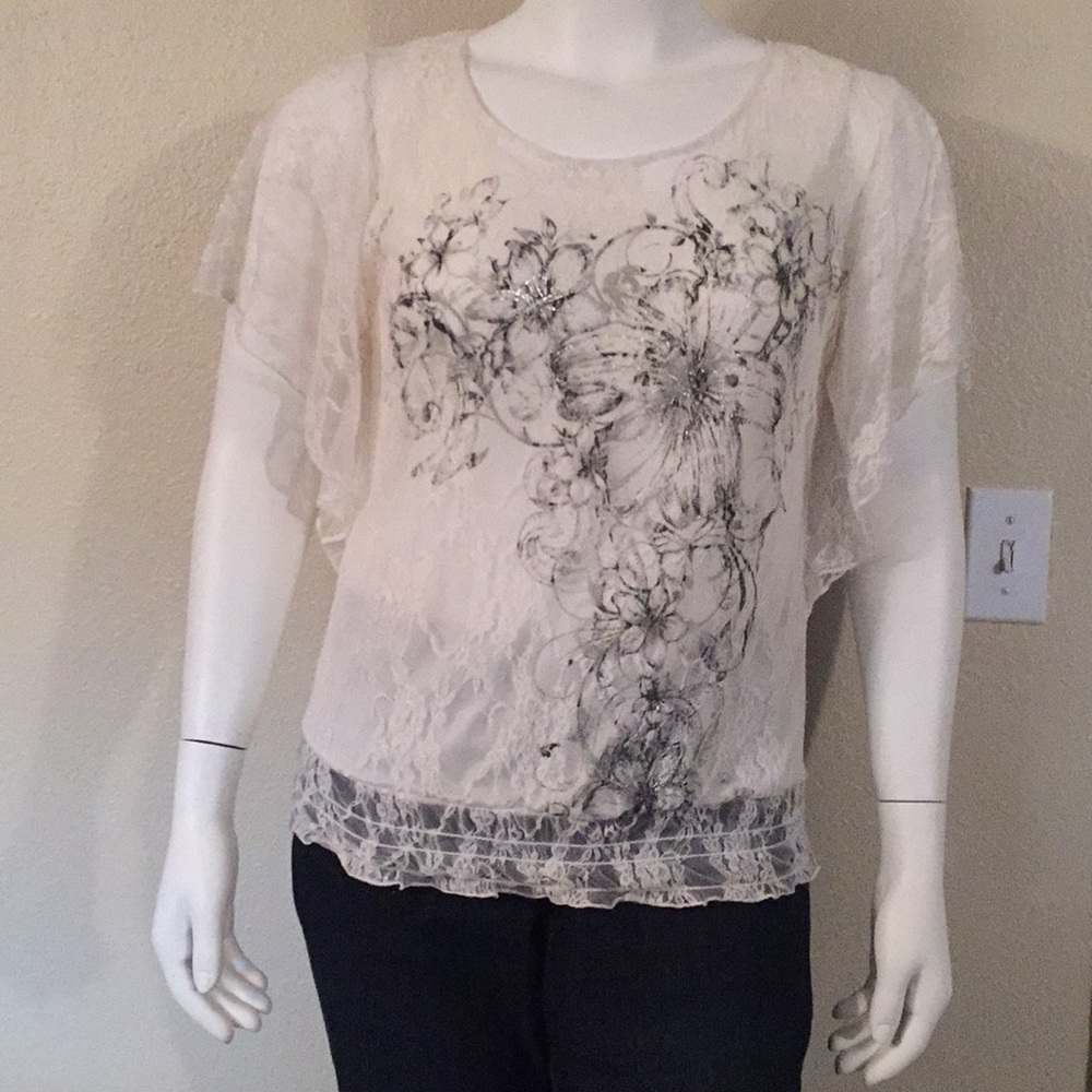 Lace blouse with black and silver floral accents.
